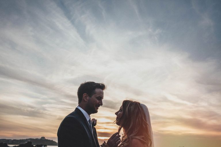 Bride and groom portraits against a lusty glaze beach sunset