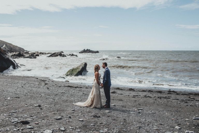 Portrait of bride and groom on the beach at tunnels beaches