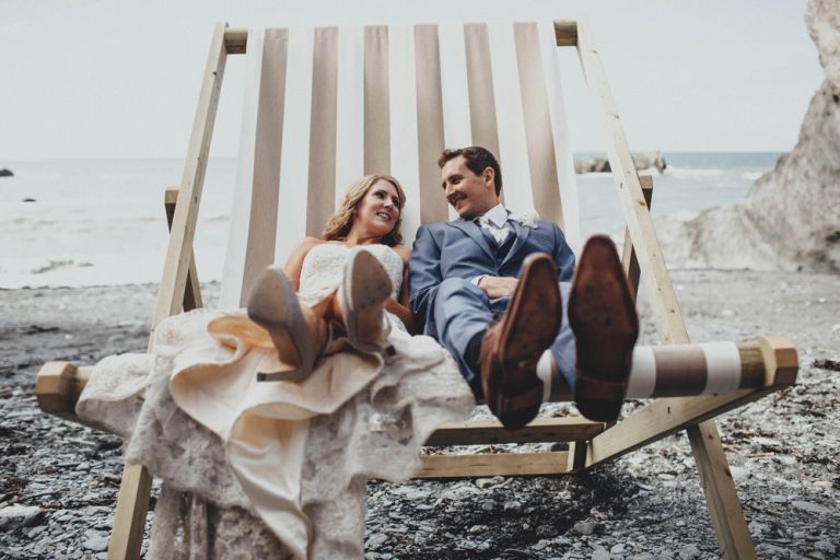 Bride and groom sat in a giant deck chair