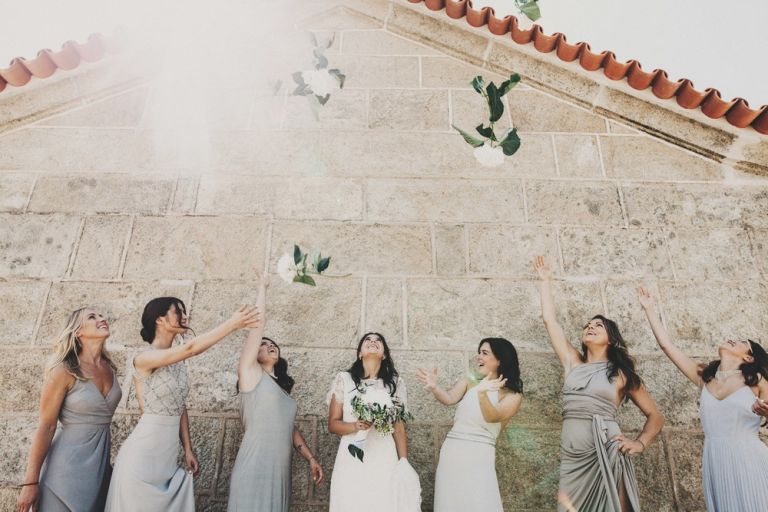 bridesmaids throwing bouquets in the air
